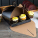 A black Enjay double cupcake tulip box with two cupcakes inside.