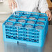 A woman using a blue Carlisle glass rack to store glasses.