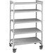 A grey metal Cambro Camshelving® Premium mobile shelving unit with wheels.