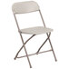 A beige Flash Furniture folding chair with a metal frame.