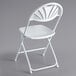 A Lancaster Table & Seating white plastic folding chair with a fan back.