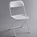 A white Lancaster Table & Seating folding chair with a white frame.