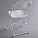 A white Lancaster Table & Seating folding chair with a metal frame.