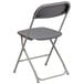 A grey Flash Furniture folding chair with a backrest and folding seat.