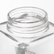 An American Metalcraft clear square glass cheese/spice shaker with a stainless steel lid with a spiral ring.