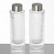 Two clear glass American Metalcraft salt and pepper shakers with silver ribbed lids.