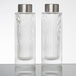 A couple of clear glass American Metalcraft salt and pepper shakers with silver lids.