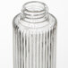 A close-up of an American Metalcraft ribbed glass salt and pepper shaker set with metal lids.