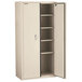 A tan metal FireKing storage cabinet with white doors and a black handle.