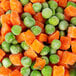 A close up of a pile of frozen peas and carrots.