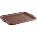 A brown plastic bus tub lid on a brown tray.
