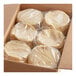 A box of Mission yellow corn tortillas stacked in plastic bags.