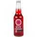 A close up of a 12 fl. oz. bottle of red Izze sparkling juice.