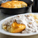 A plate of food with Chef-Mate country sausage gravy and potatoes.