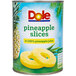 A can of Dole pineapple slices in pineapple juice with a pineapple ring on top.