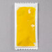 A yellow packet of yellow mustard sauce.