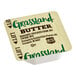 A container of Grassland butter portion cups.