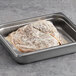 A metal pan of Original Philly Cheesesteak Co. fully cooked sliced beef steak.
