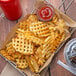 A red basket of Lamb Weston CrissCut Waffle Fries with a cup of ketchup.