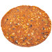 A close up of a Gardein Black Bean Veggie Burger, a round brown patty with different colored specks.