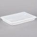 A white plastic Cambro food storage box on a gray surface.