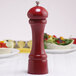 A red Chef Specialties pepper mill on a table.