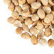 A close up of a pile of extra large roasted salted blanched peanuts.
