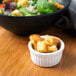 A bowl of salad with Fresh Gourmet croutons on a table in a salad bar.