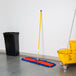 A Lavex all-in-one microfiber dust mop with a yellow bucket.