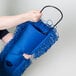 A woman using a Lavex all-in-one microfiber dust mop with a blue handle.