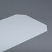 A white translucent Metro shelf inlay on a grey surface.