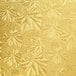 A close up of a gold patterned surface with floral designs on an Enjay gold round cake drum.