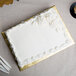 A white cake on a gold Enjay cake board.