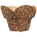 A dark brown cupcake wrapper with a gold pattern of lotus flowers and crowns.