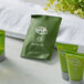 A white towel with a group of green Noble Eco Novo Terra shower cap packages.