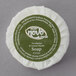 A round white Noble Eco Novo Terra soap disc in a green wrapper.