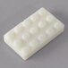 A white rectangular soap bar with circles on it.