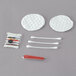 A Noble Eco Novo Terra hotel and motel grooming kit with cotton swabs and sticks, a toothbrush, scissors and a needle.