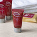 A group of red Noble Eco Novo Natura body wash tubes with white text.