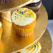 A Enjay 5-tier disposable gold cupcake treat stand with cupcakes on a gold tray.