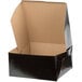 A black Enjay cake box with a brown lid.