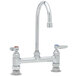 A chrome T&S deck-mounted pantry faucet with swivel gooseneck nozzle and wrist action handles.