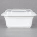 A white plastic Pactiv Newspring rectangular container with a clear lid.