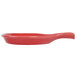 A red spoon shaped fry pan plate with a handle.