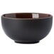 A black bowl with a brown rim.