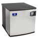 A white Manitowoc water cooled ice machine with silver and black details and a blue button.