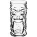 An Anchor Hocking Cooler glass with a Tiki face on it.