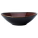 A brown porcelain ramekin with a speckled red surface.