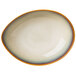A white porcelain soup bowl with an orange rim.