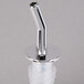 A Tablecraft chrome plastic liquor pourer with a white plastic tube and silver metal top.